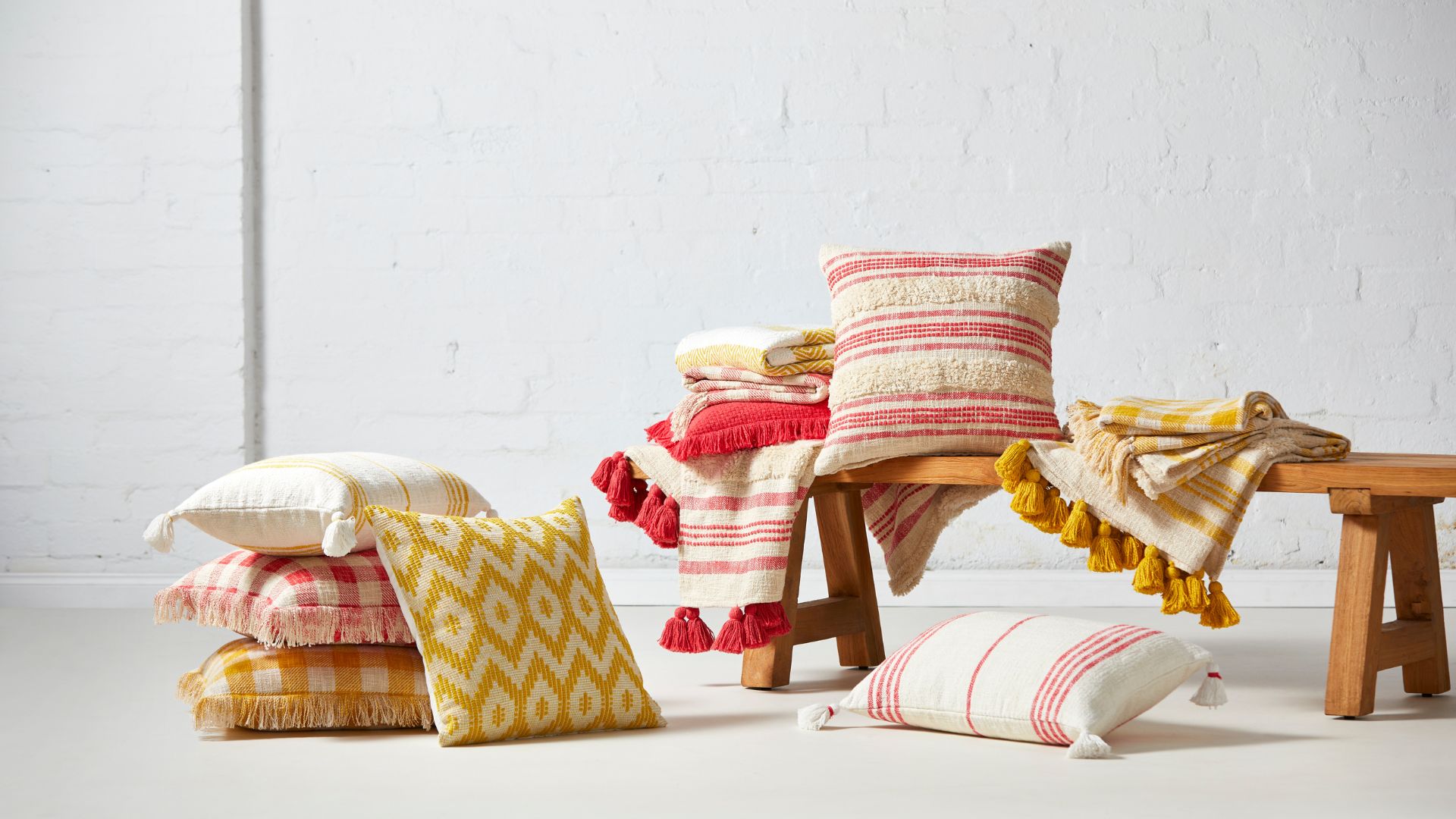 Mustard yellow and berry red stripe, gingham and geometric patterned cushions